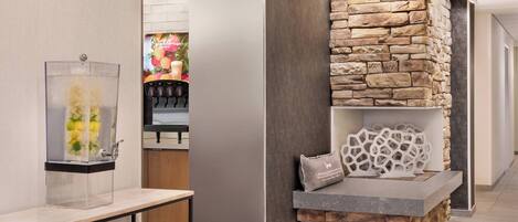 A modern interior with a stone accent wall, a clear glass display case, and a wooden reception desk.