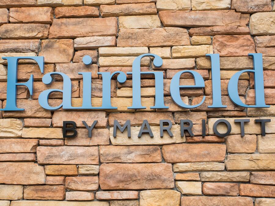 A stone wall with the text "Fairfield by Marriott" indicating a hotel name.