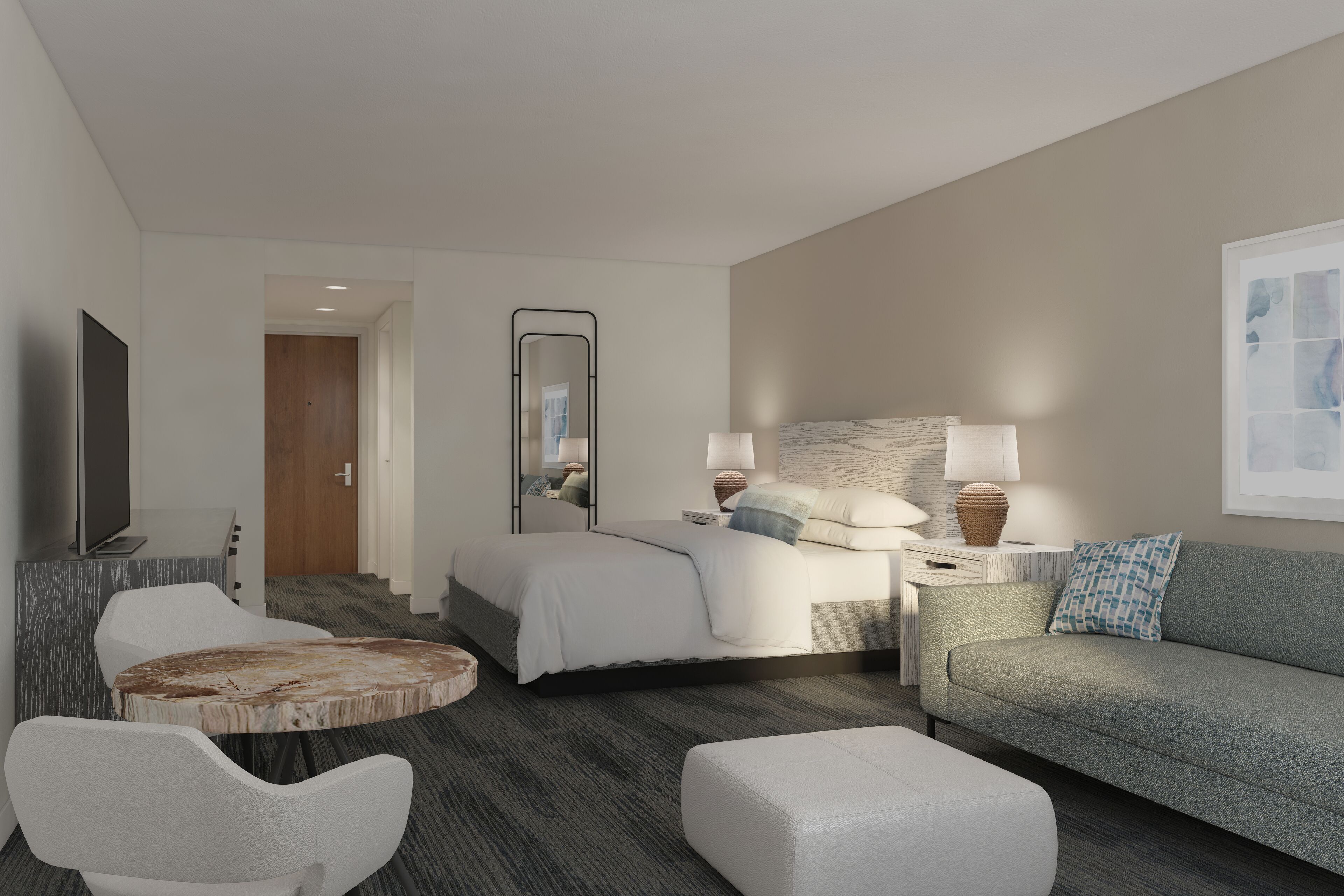 Ein modernes Hotelzimmer mit Bett, Sofa, Fernseher, Schreibtisch und Stuhl.