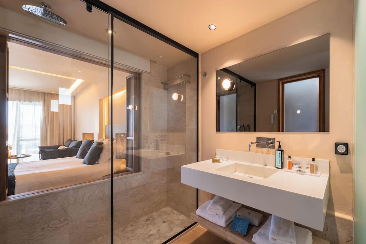 junior suite, non smoking, sea facing | bathroom | rainfall showerhead, free toiletries, hair dryer, bathrobes