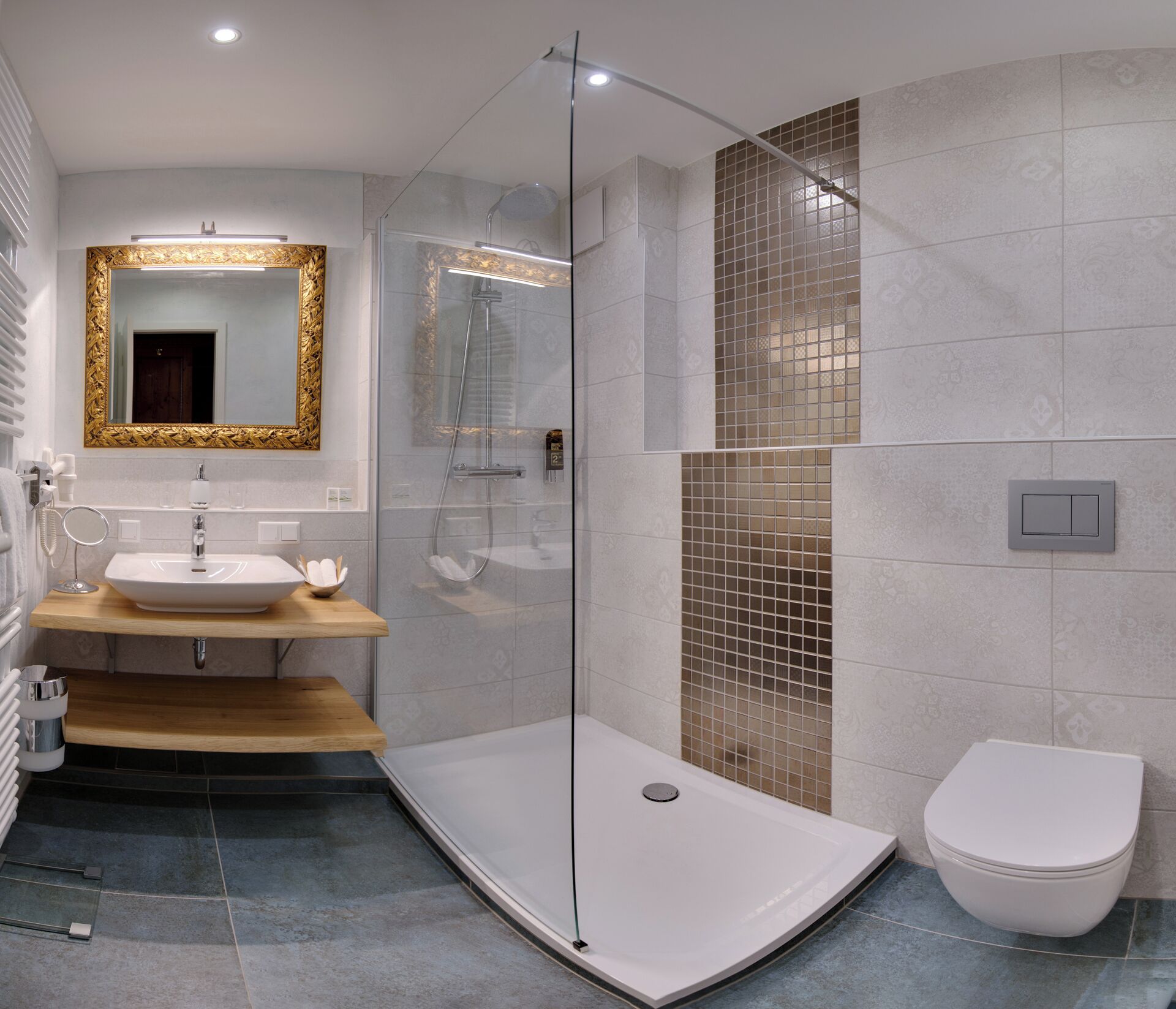 A modern bathroom with a glass-enclosed shower, a vanity with a mirror, and a toilet.