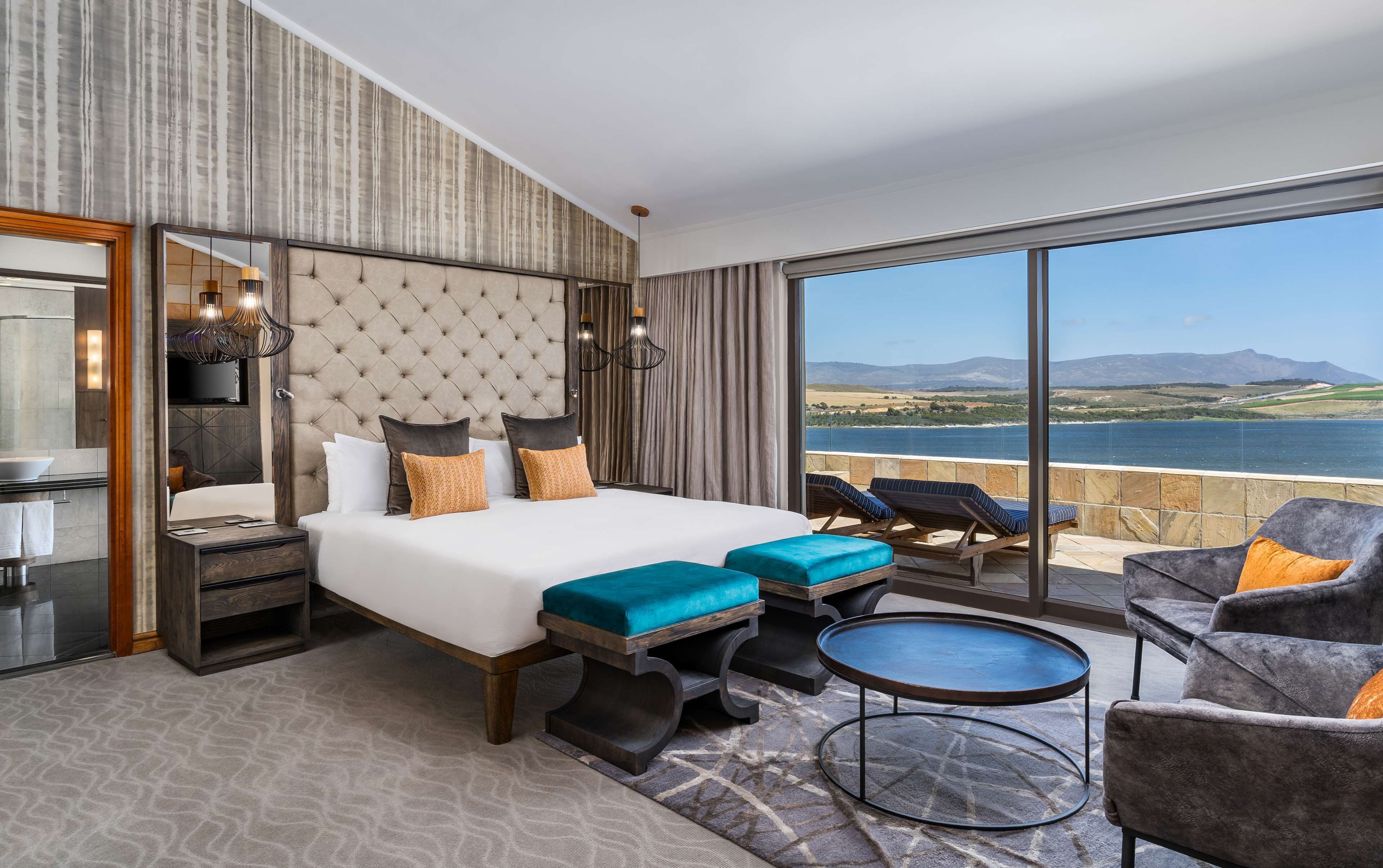 presidential suite with lagoon view | premium bedding, in-room safe, desk, laptop workspace