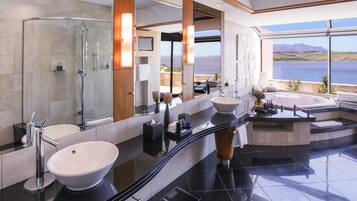 A modern bathroom with a large mirror, two sinks, a shower, and a bathtub.