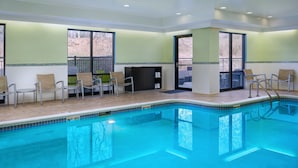 A pool area with chairs and a changing room.