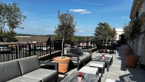 An outdoor seating area with sofas, tables, and potted plants. - Crowne Plaza East Midlands Airport by IHG (Kegworth)