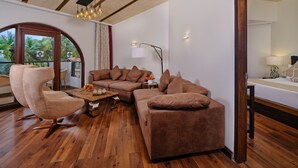 A modern living room with a sectional sofa, a round armchair, and a wooden coffee table.