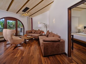 A modern living room with a sectional sofa, a round armchair, and a wooden coffee table.