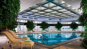 An indoor swimming pool with lounge chairs, a glass ceiling, and potted plants. - The Hongta Hotel, a Luxury Collection Hotel, Shanghai (Shanghai)