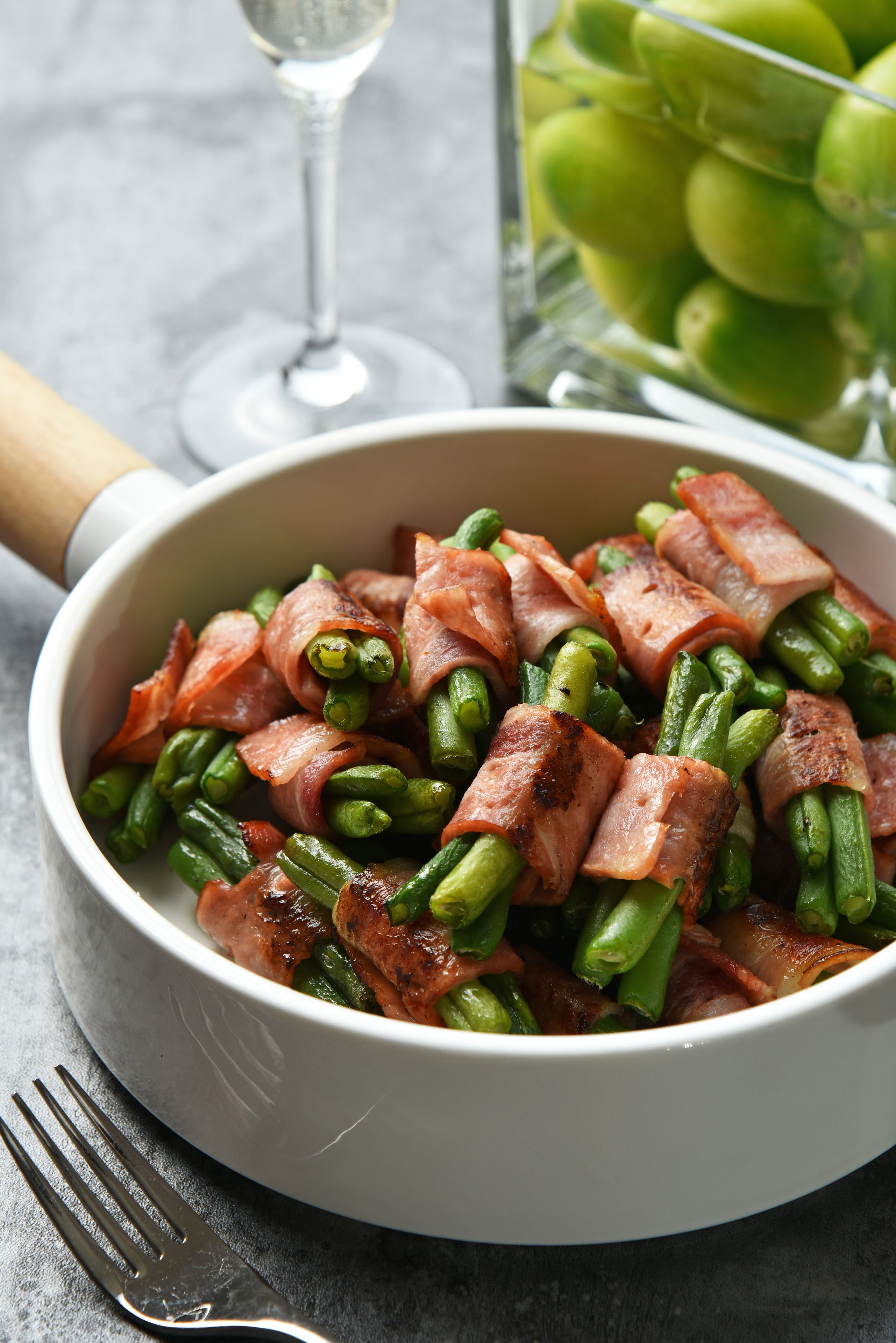 Un plat de haricots verts enroulés de lardons.