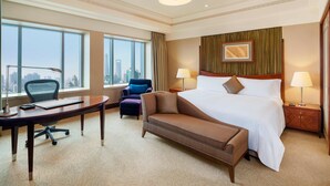 A hotel room with a large bed, a desk, a chair, and a view of a cityscape. - The Hongta Hotel, a Luxury Collection Hotel, Shanghai (Shanghai)