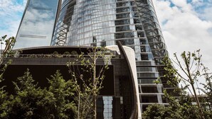 A modern skyscraper with a unique twisted design, surrounded by other tall buildings and trees. - The Hongta Hotel, a Luxury Collection Hotel, Shanghai (Shanghai)