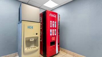 A vending machine with a Coca-Cola logo and an ice dispenser.