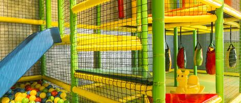A children's play area with a ball pit, slides, and climbing structures.