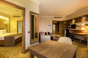 Senior Suite | Minibar, in-room safe, desk, laptop workspace