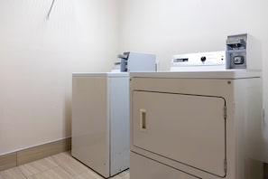A laundry room with two stacked washing machines and a dryer. - Red Roof Inn PLUS+ & Suites Savannah - I-95 (Savannah)