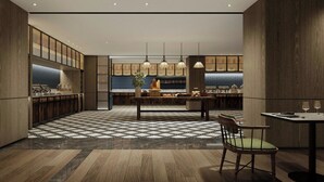 Une cuisine moderne dotée d’un îlot central, de luminaires suspendus et d’un carrelage à motifs à carreaux.