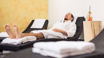 Guests can unwind in this serene space, featuring a massage chair and refreshments.