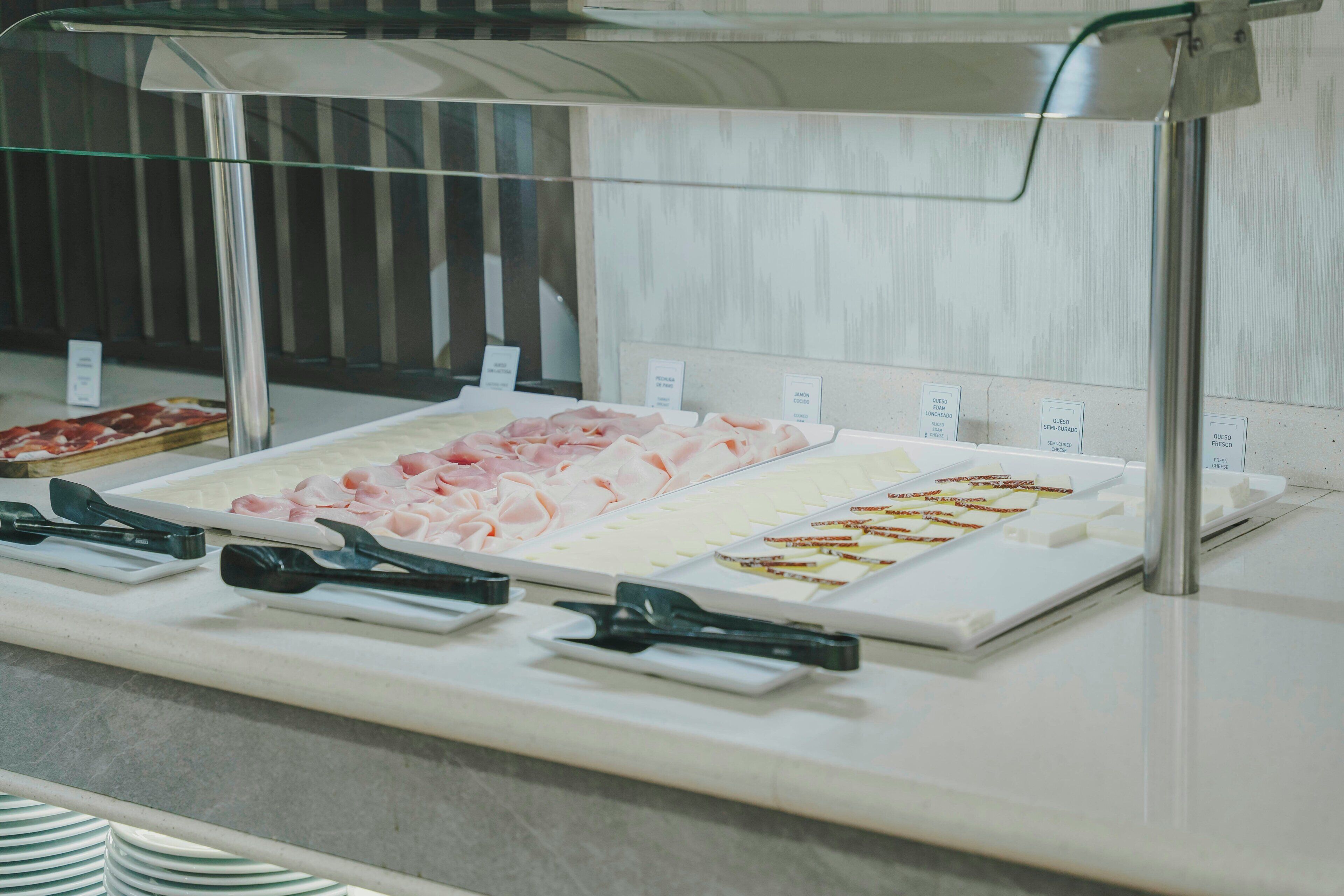 A buffet with various food items and serving utensils.