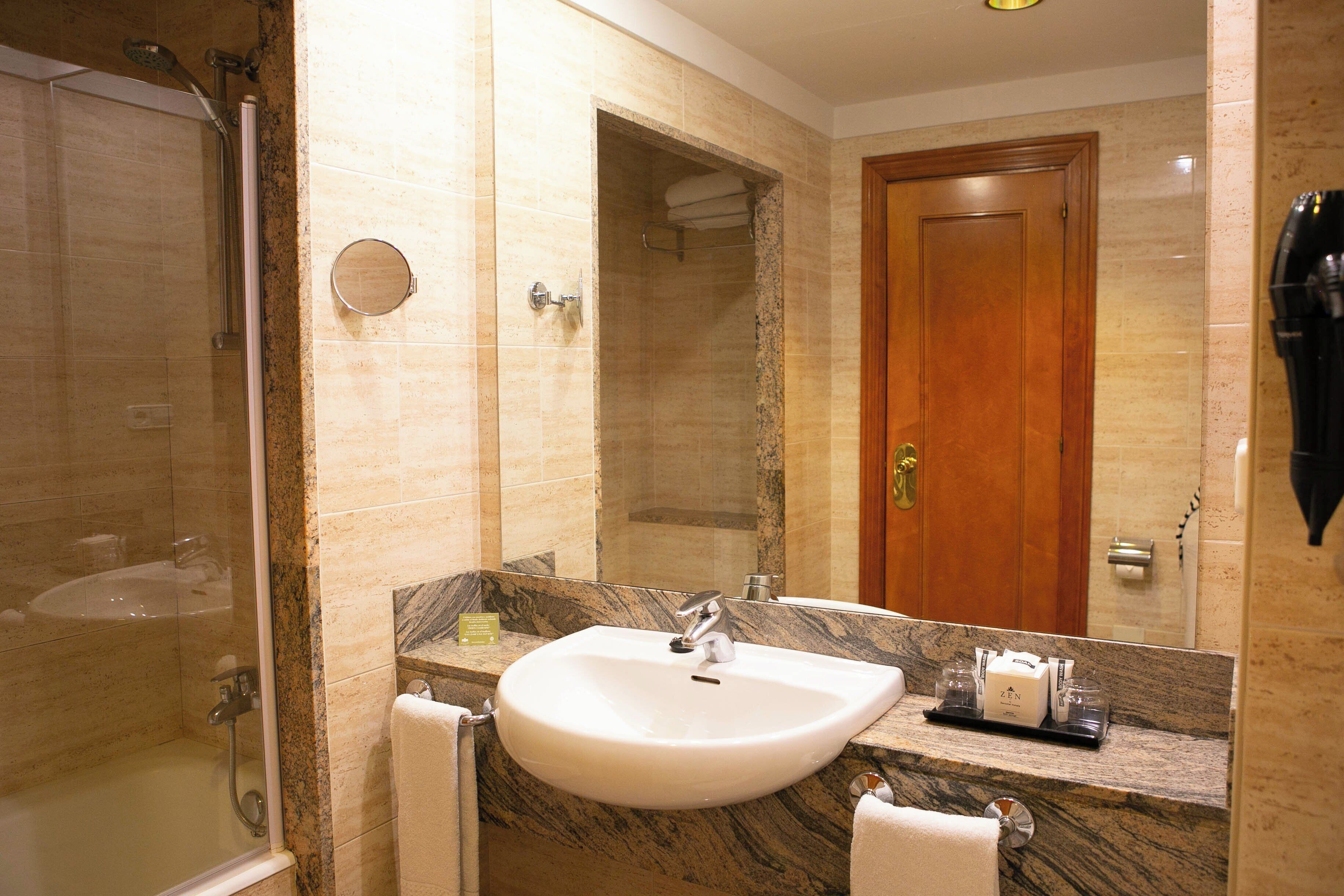 bathtub, free toiletries, hair dryer, towels