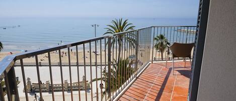 Un balcón con vista a la playa y al mar.