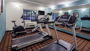 A gym with treadmills, an elliptical, and a stationary bike. - Super 8 by Wyndham Beaumont I-10 South/College St (Beaumont)