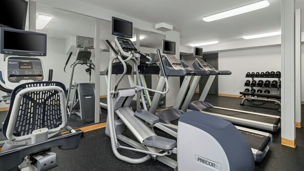 A gym with treadmills, elliptical machines, and a weight rack. - TownePlace Suites by Marriott -Minneapolis West/StLouis Park (St. Louis Park)