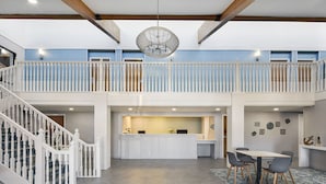 A spacious interior with a staircase, a reception desk, and a dining area. - Hotel Wave Rehoboth Beach (Rehoboth Beach)
