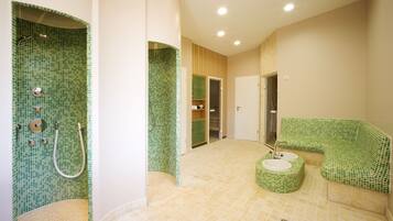 Bathroom features a unique design with a mosaic tile wall and a cushioned bench.