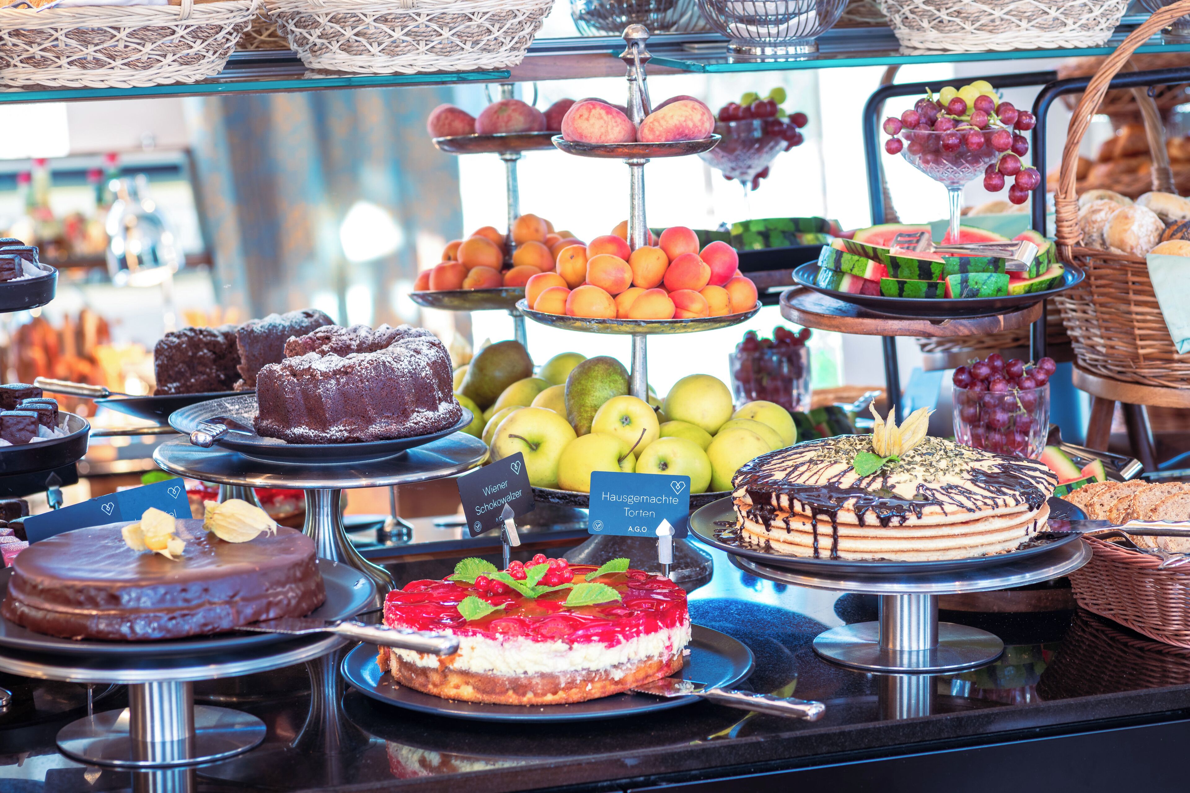 A variety of desserts and fruits displayed on a counter.