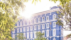 A multi-story building with a blue facade, multiple windows, and a street in front. - BoutiqueHOTEL Donauwalzer (Vienna)