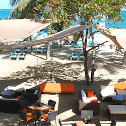 On the beach, white sand, sun-loungers, beach towels