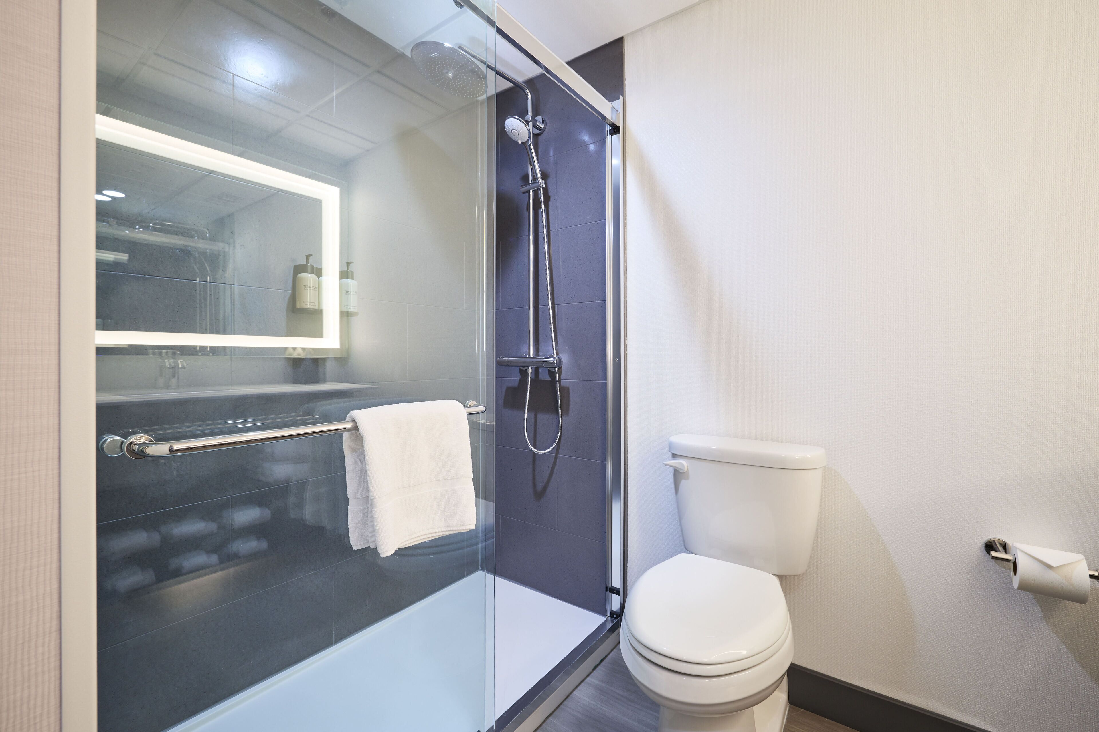 combined shower/bathtub, designer toiletries, hair dryer, towels