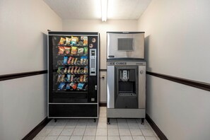 A vending machine with snacks and a separate ice dispenser. - Red Roof Inn Atlanta Southeast - Stockbridge (Stockbridge)