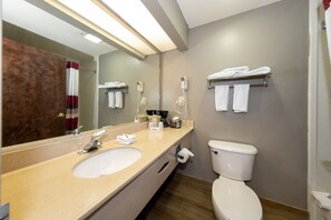 A bathroom with a sink, mirror, towel rack, and toilet. - Red Roof Inn Atlanta Southeast - Stockbridge (Stockbridge)