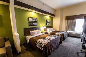 A hotel room with two beds, a desk, a chair, and a window with curtains. - Sleep Inn & Suites Orlando International Airport (Orlando)