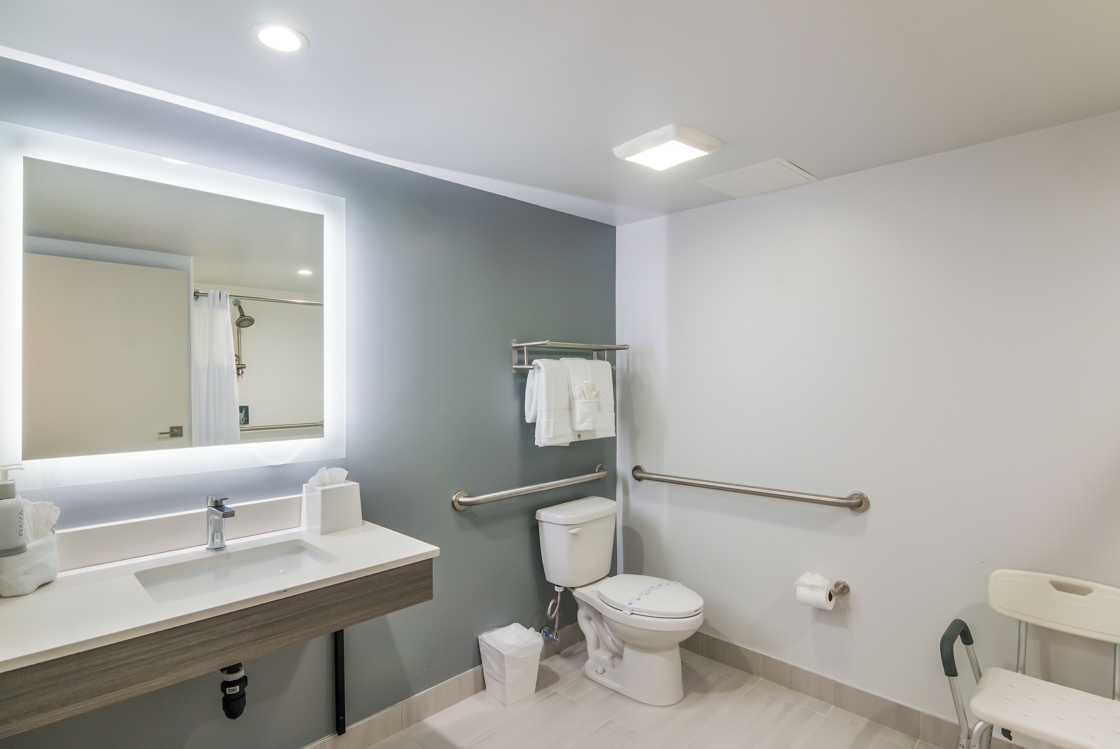 designer toiletries, hair dryer, towels