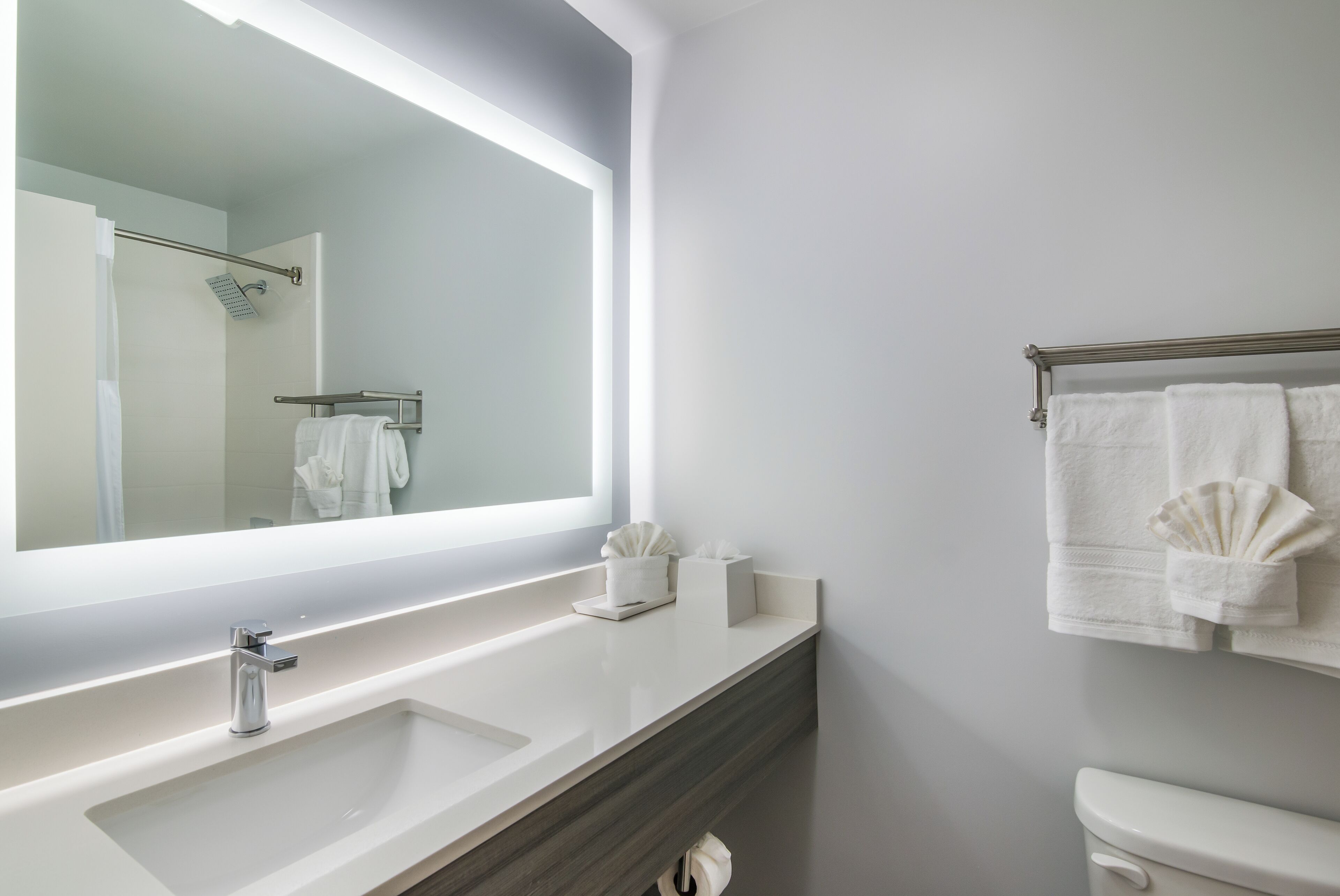 designer toiletries, hair dryer, towels