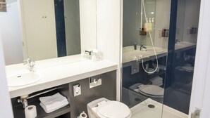 A modern bathroom with a glass-enclosed shower, a white sink, and a toilet. - Holiday Inn York City Centre by IHG (York)