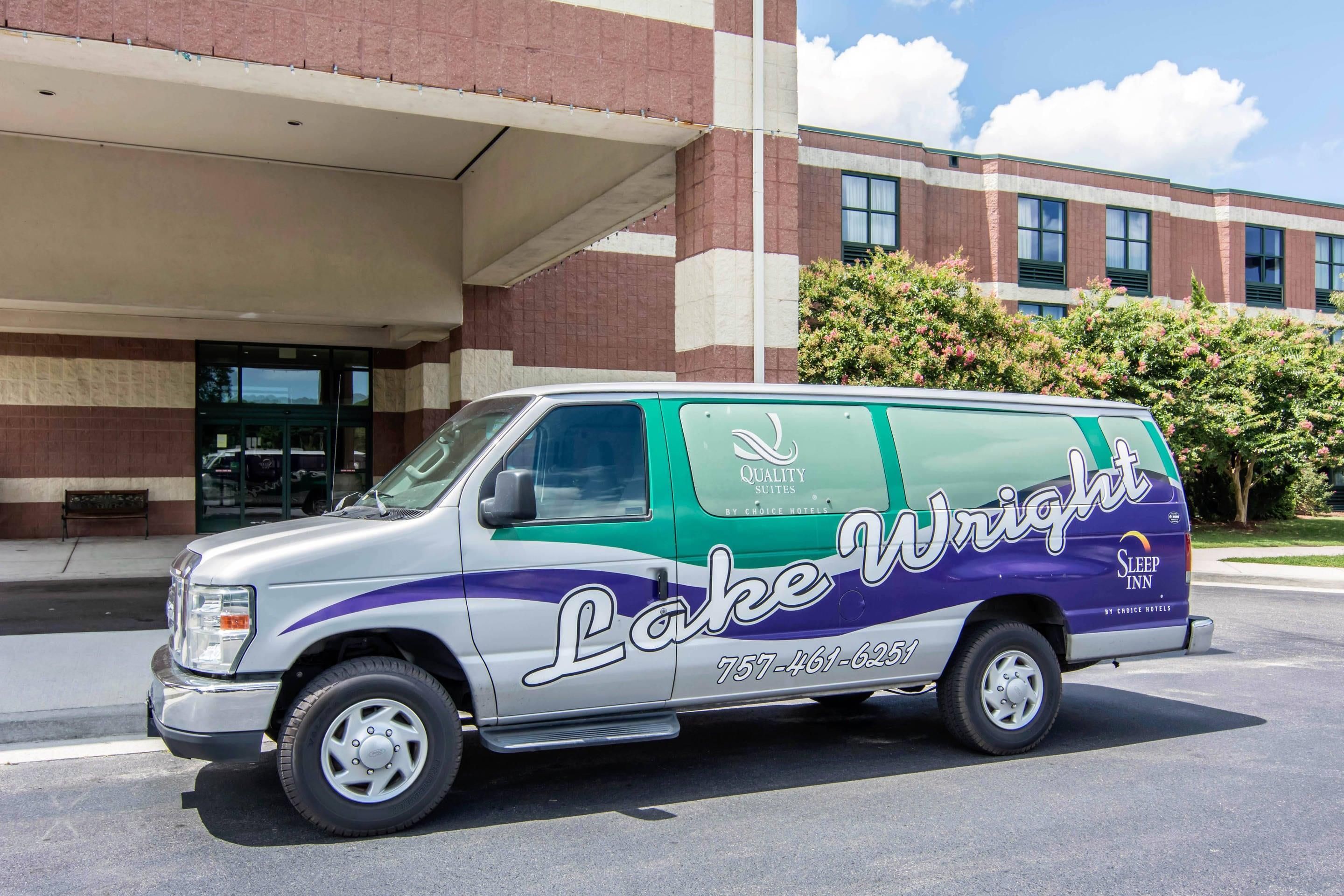 A commercial van with 'Lake Wright Sleep Inn' branding parked in front of a building.