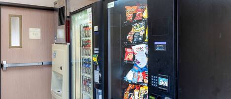 A vending machine with snacks and a water dispenser.