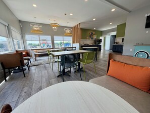 A modern interior with a dining area, kitchen, and seating space.