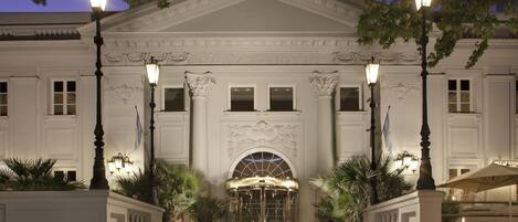 A grand entrance with a central archway, flanked by columns and ornate decorations.