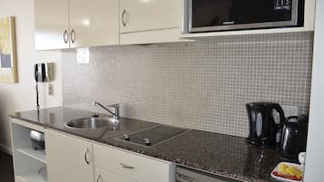 Fridge, microwave, stovetop, coffee/tea maker
