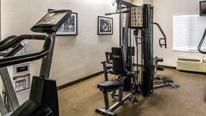 A gym with cardio equipment, weight machines, and a wall-mounted TV. - Sleep Inn Fort Pierce I-95 (Fort Pierce)