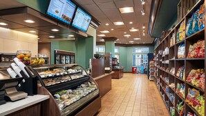 A deli counter with a variety of prepared foods and a refrigerated display.