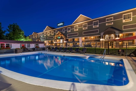 Seasonal outdoor pool, open 8:00 AM to 8:00 PM, pool umbrellas. Maine Evergreen Hotel, an Ascend Collection Hotel
