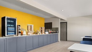 A modern kitchen with a built-in refrigerator, a coffee machine, and a microwave. - City Express By Marriott Gettysburg (Gettysburg)