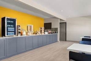 A modern kitchen with a built-in refrigerator, a coffee machine, and a microwave. - City Express By Marriott Gettysburg (Gettysburg)