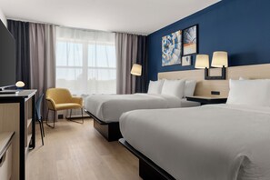 A hotel room with two beds, a desk, a chair, and a window with curtains. - City Express By Marriott Gettysburg (Gettysburg)