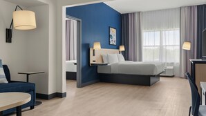 A modern hotel room with a bed, bedside lamps, a desk, and a chair. - City Express By Marriott Gettysburg (Gettysburg)